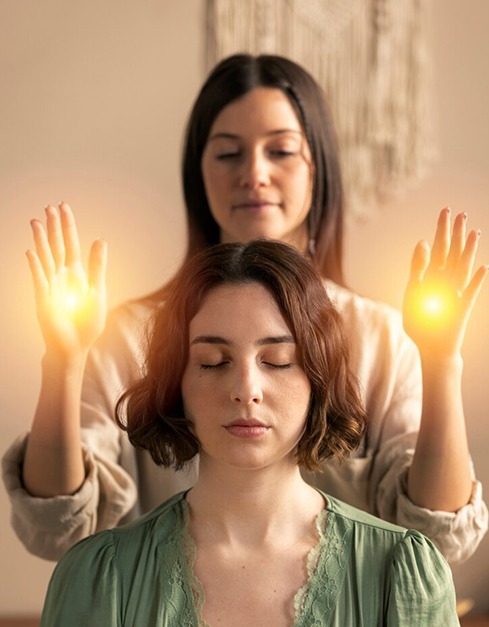 Reiki healing session with glowing therapist hands