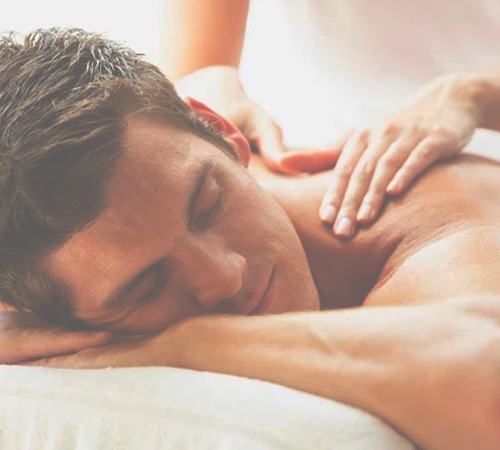 Man enjoying a relaxing shoulder massage in a spa setting