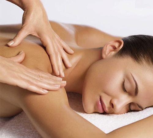 Woman receiving a relaxing remedial back massage while lying on a massage table